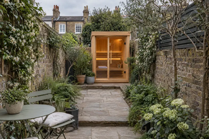 Compact sauna at the end of a narrow terraced-house garden